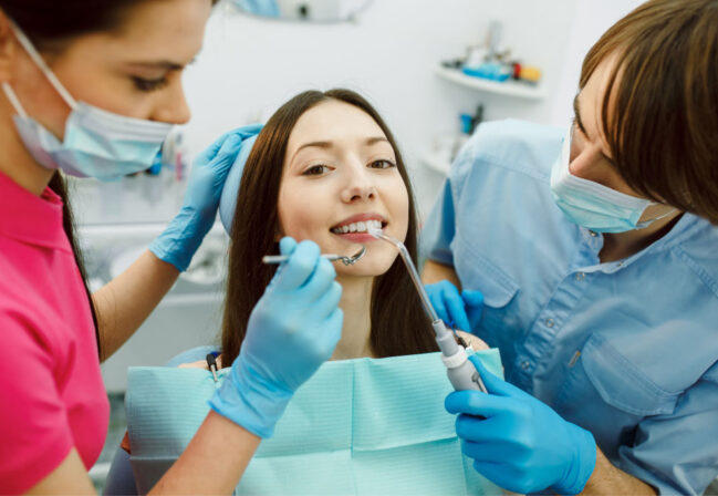 dentist inspect woman teeth