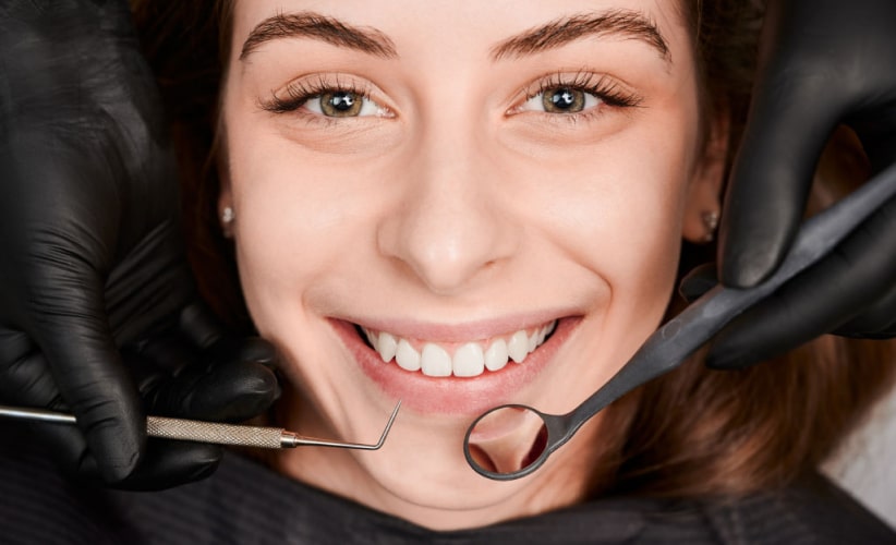 cheerful-young-woman-having-dental-examination-clinic