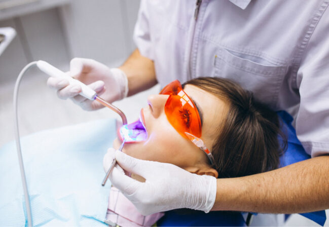 dentist polishing patient teeth